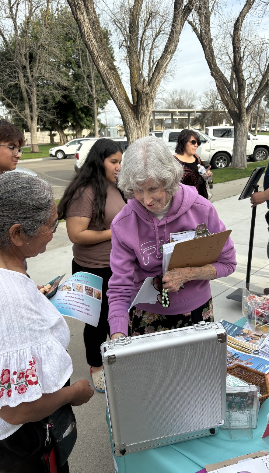 Right to Life volunteers sharing resources at an outreach table