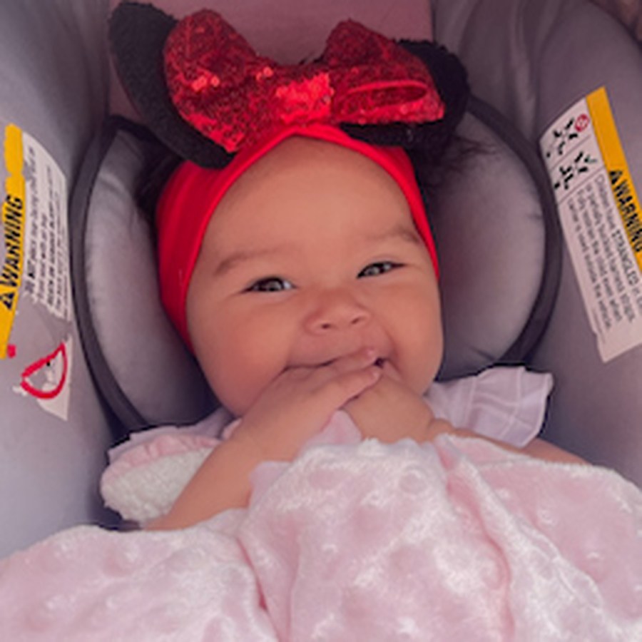 Harmony's baby smiling in a car seat